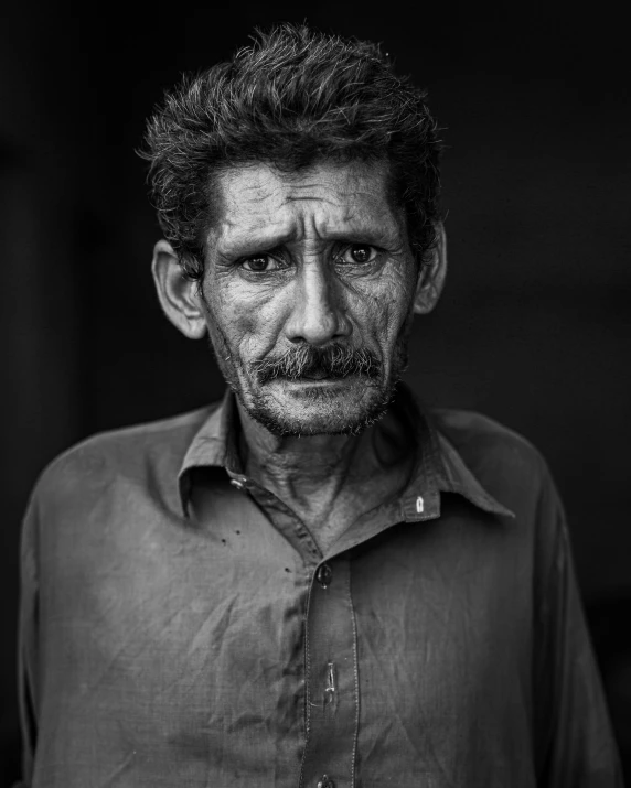 a black and white photo of a man with a mustache, inspired by Steve McCurry, insanly detailed, sad men, indian, a photo of a disheveled man