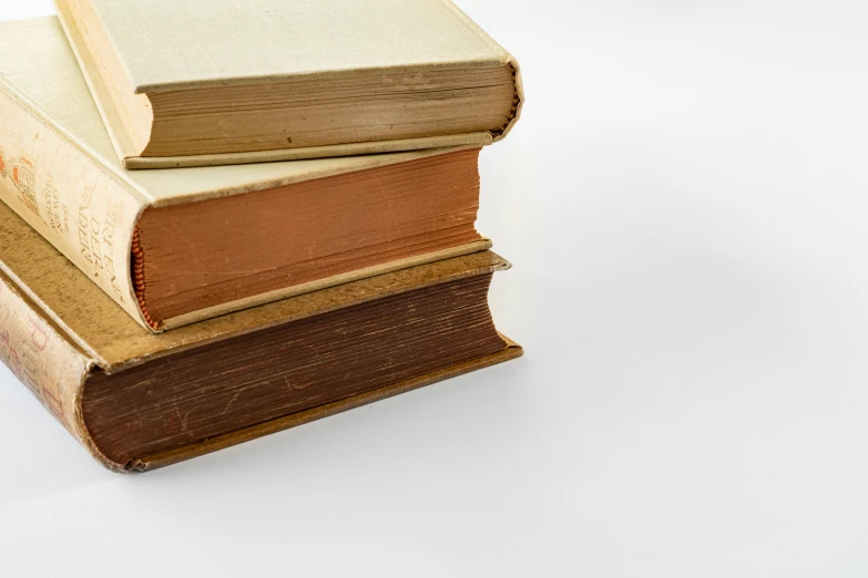 a stack of books sitting on top of each other, an album cover, unsplash, tonalism, ivory and copper, 1820, plain background, 3 colours