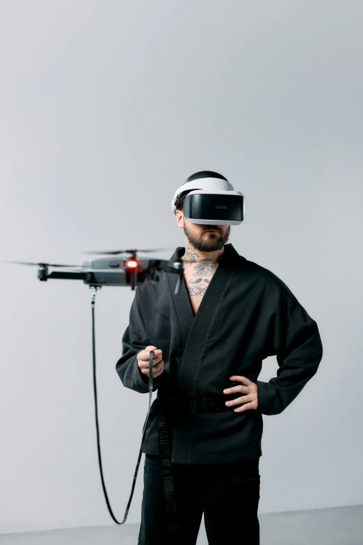 a man wearing a suit and holding a hair dryer, a hologram, by Paul Bird, reddit, helicopter drones, technoviking male with no shirt, tech robes, looking towards camera