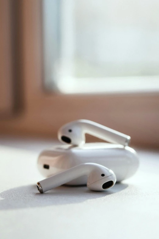 a pair of airpods sitting on top of a table, by Niko Henrichon, trending on pexels, happening, white mechanical details, aircraft, profile shot, made of glazed