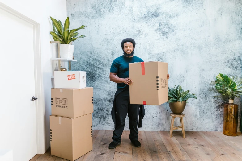 a man holding a cardboard box in a room, different sizes, riyahd cassiem, 6 pack, multi-part