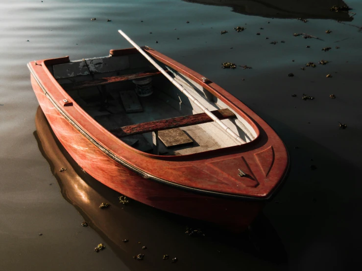 a red boat sitting on top of a body of water, pexels contest winner, photorealism, faded glow, dark dingy, polished with visible wood grain, thumbnail