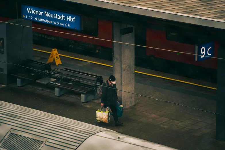 the woman is walking along the train platform