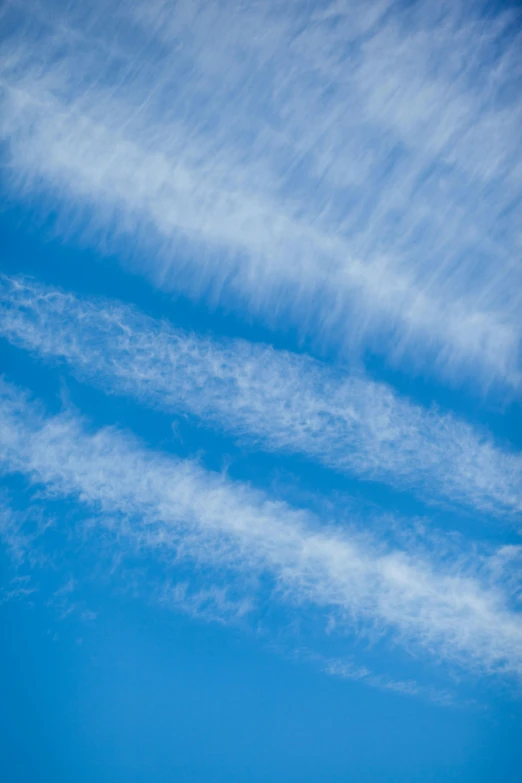 two planes flying in the sky with a cloudy blue background