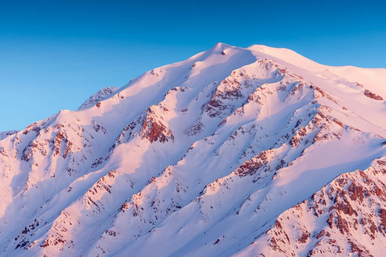 a mountain that has some snow on it