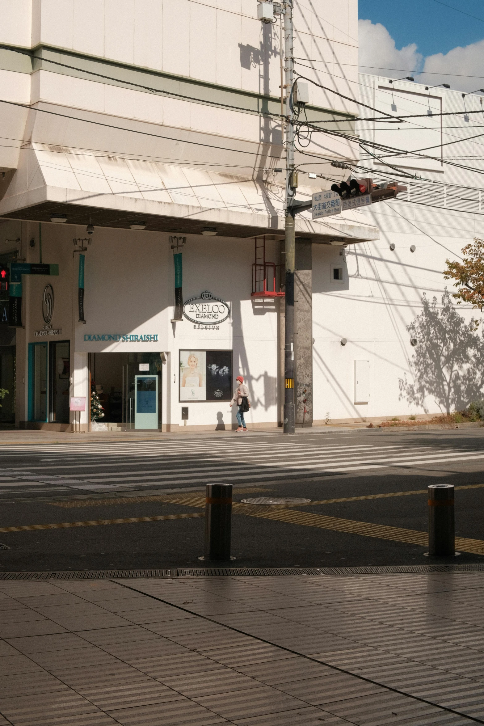 a city street with a stop sign and wires above it