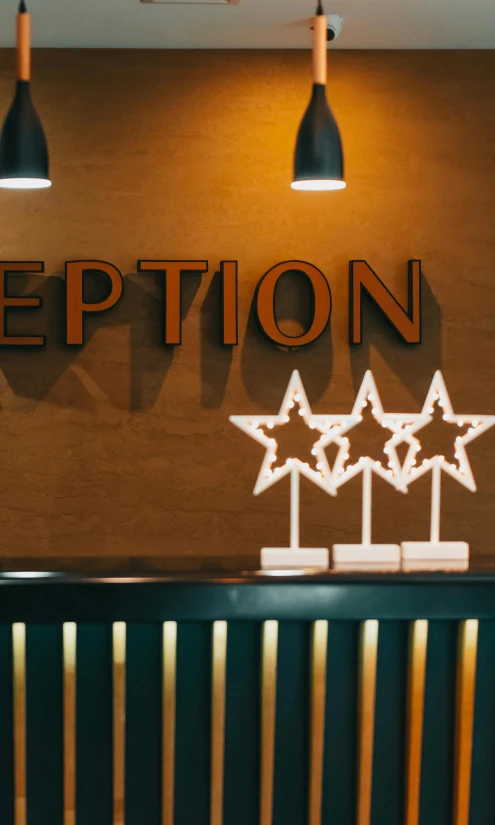 the reception desk has three star - shaped star decorations