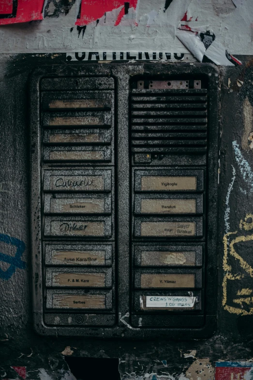 a phone sitting on top of a wall covered in graffiti, an album cover, by Jacob Toorenvliet, unsplash, graffiti, old experimentation cabinet, greeble detail, location [ chicago ( alley ) ], control panel