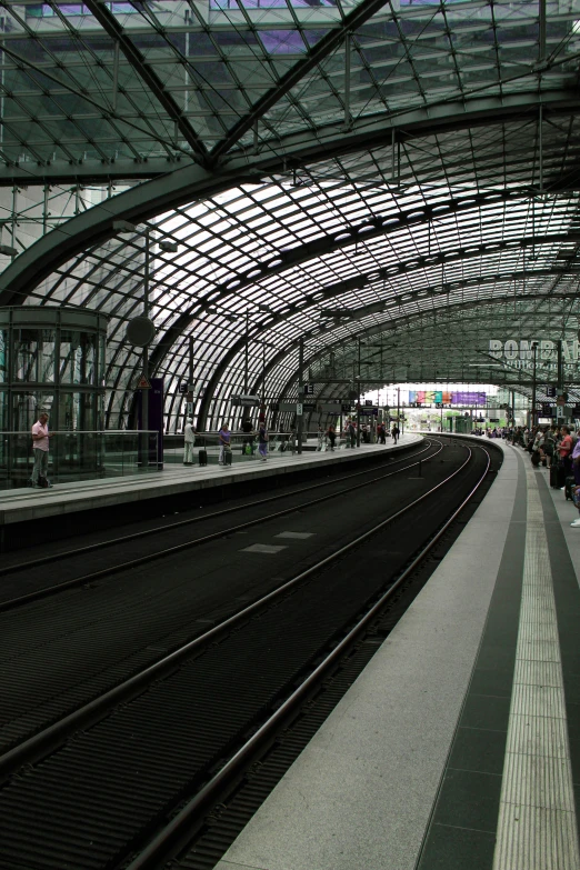 a train station with people waiting on the platform, inspired by Georg Friedrich Schmidt, flickr, rounded roof, really clear, about to step on you, cables everywhere