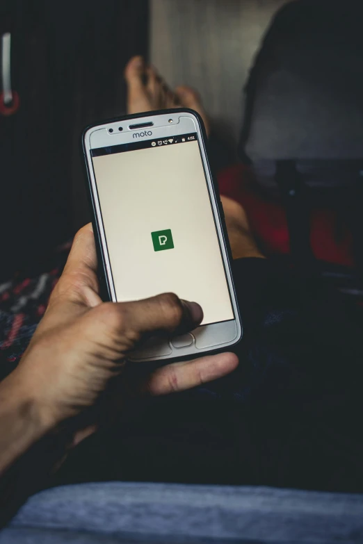 a close up of a person holding a cell phone, pexels, happening, wearing green, square, dating app icon, dingy