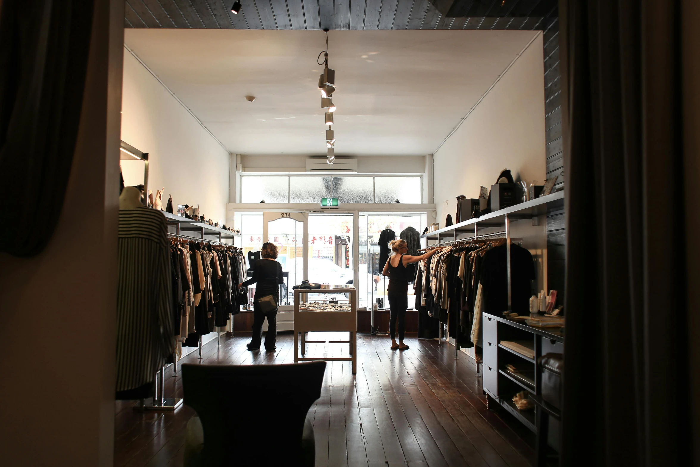 a store with the doors open and people walking inside