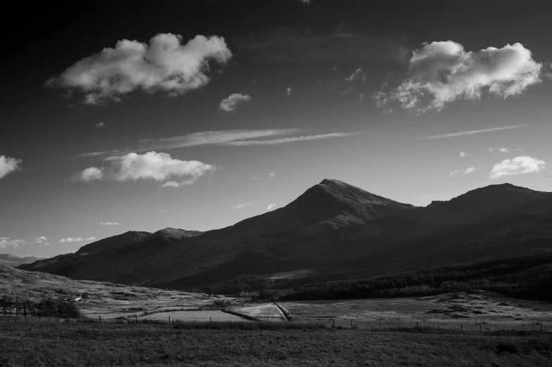 the mountain range is full of trees and clouds