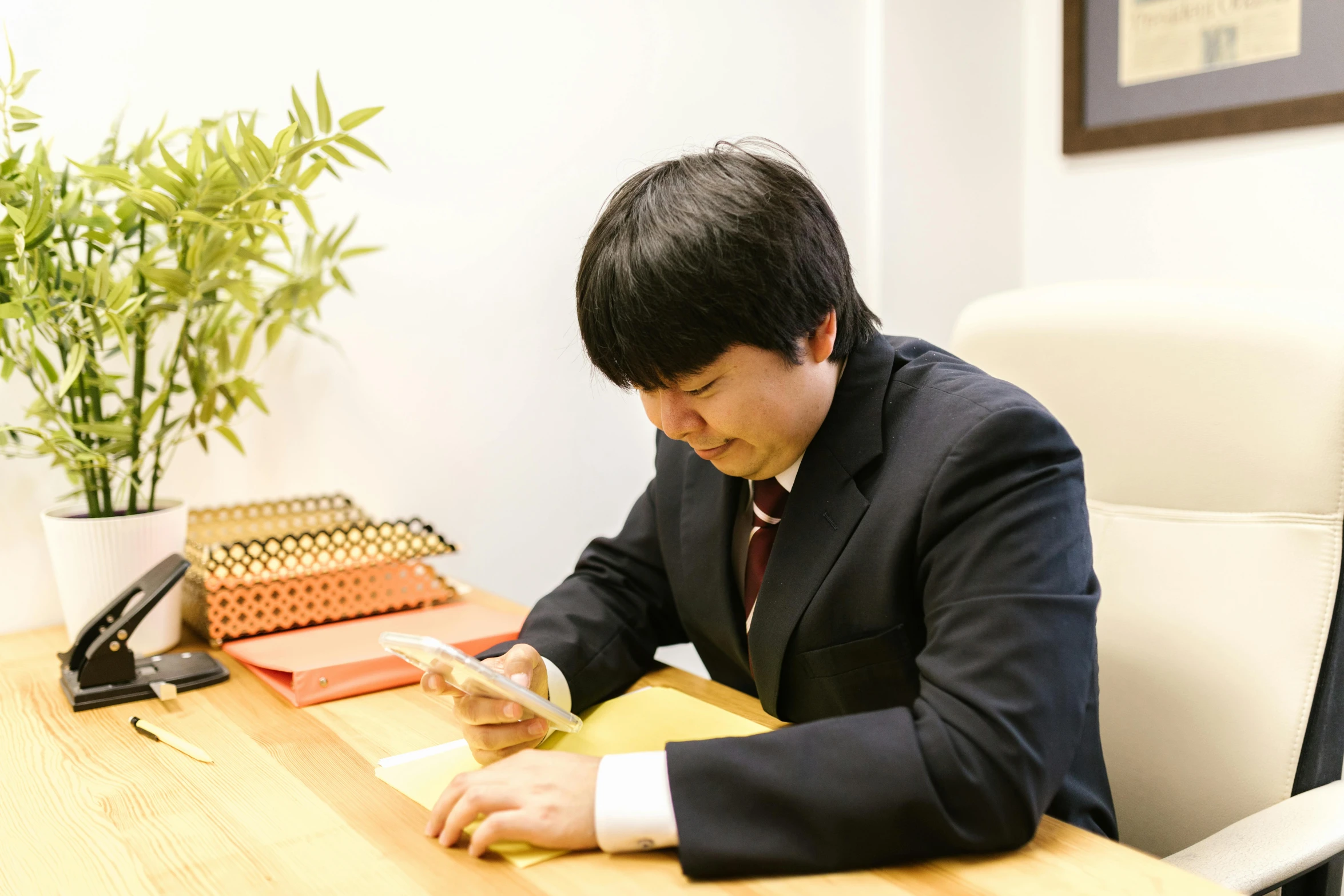 a man in a suit sitting at a desk