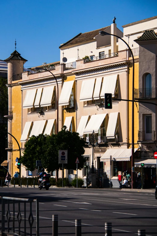 a tall building with lots of windows next to a street