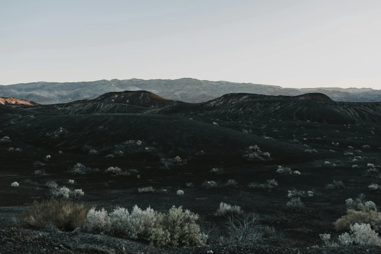 a view of a desert with mountains in the distance