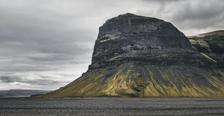 the tall mountain is surrounded by clouds and rock