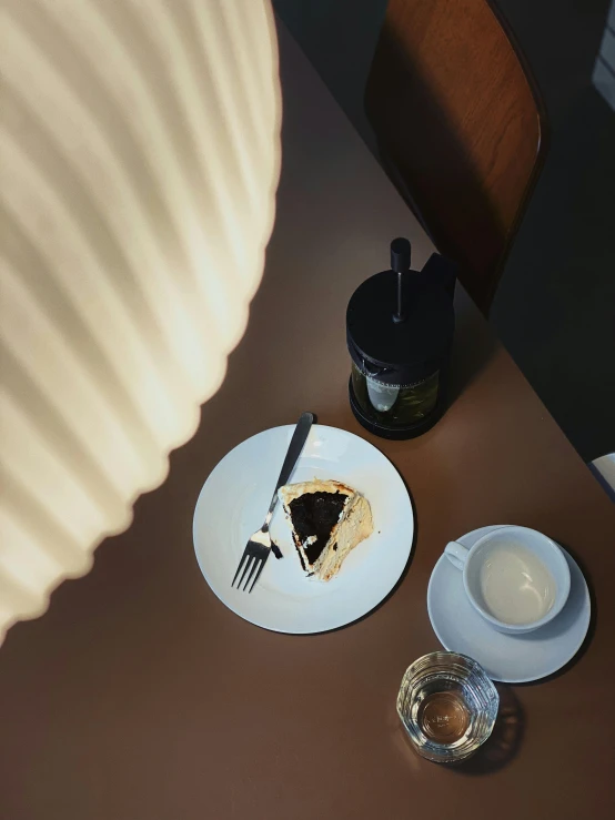 a close up of a plate of food on a table, a picture, inspired by Constantin Hansen, trending on unsplash, photorealism, emerging from a lamp, coffee shop, ignant, high angle close up shot