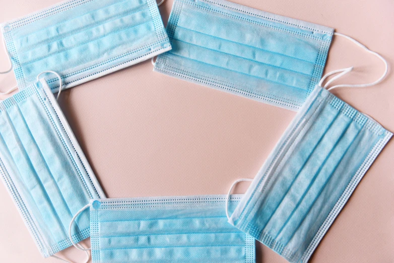 five disposable face masks arranged in a circle, trending on pexels, plasticien, background image, rectangular, pink, surgeon