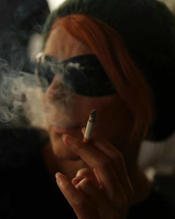 an orange headed woman smoking a cigarette