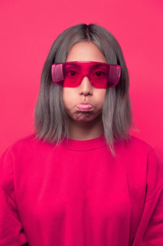 a woman wearing red glasses making a funny face, an album cover, inspired by Warhol, trending on pexels, magenta and gray, pokimane, jelly, loosely cropped