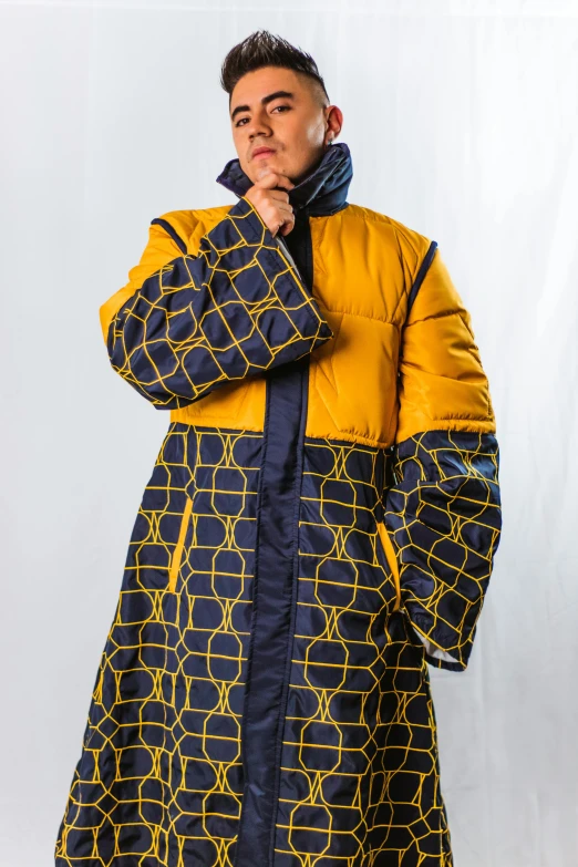 a man in yellow coat posing for the camera