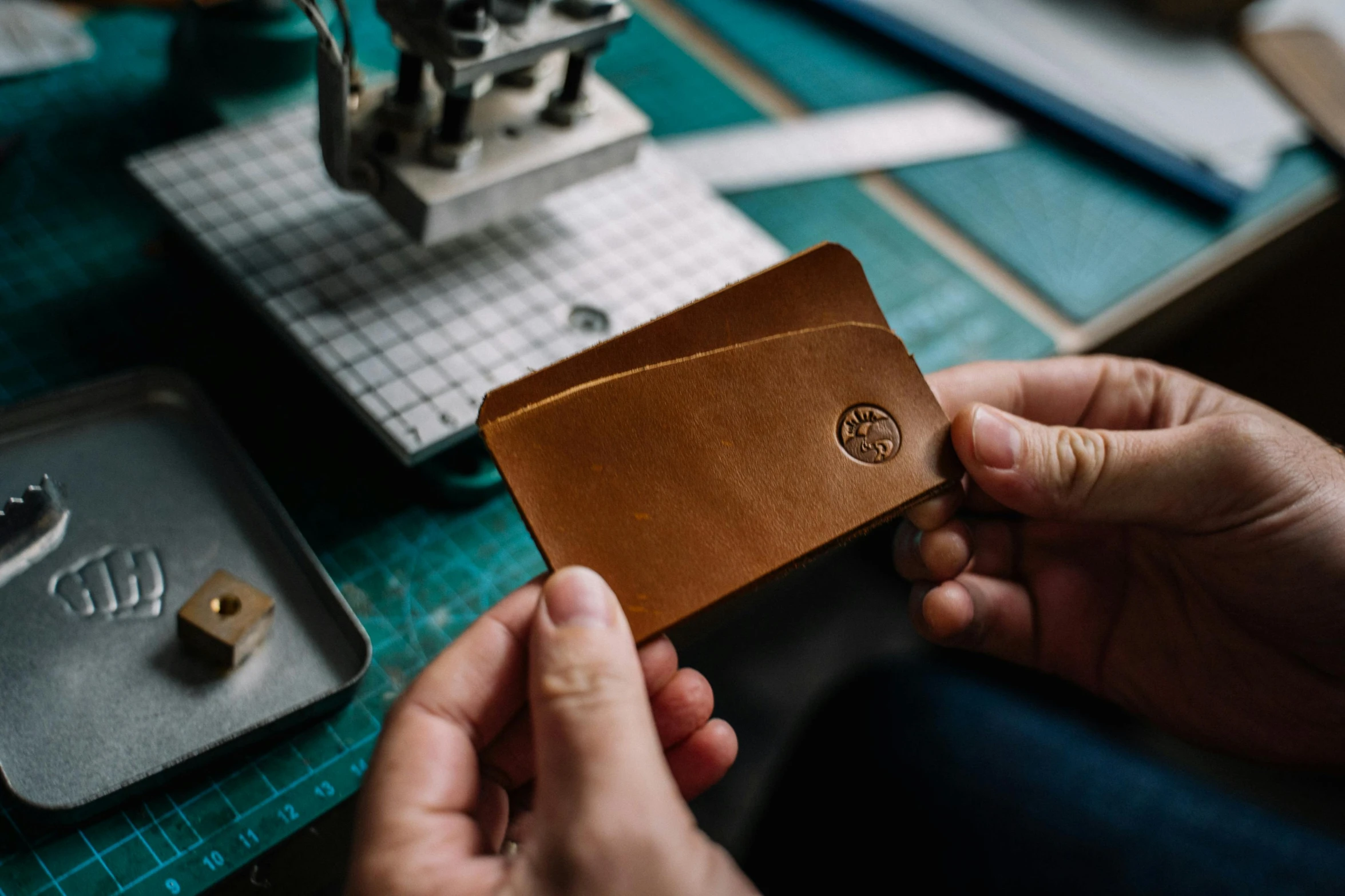 a close up of a person holding a wallet, an etching, featured on instagram, small manufacture, detailed product image, pair of keycards on table, handcrafted