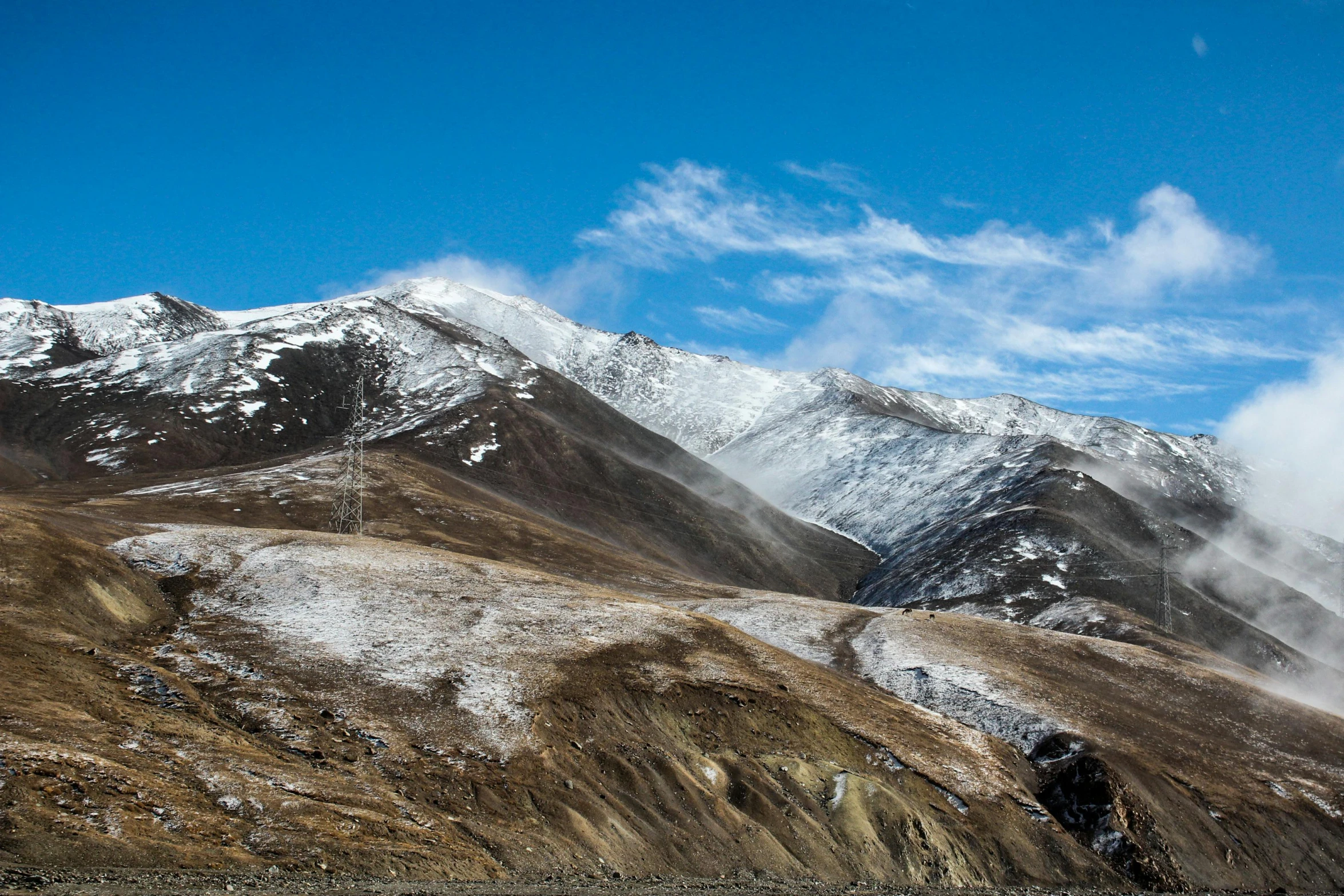 the mountains with a few snow on them