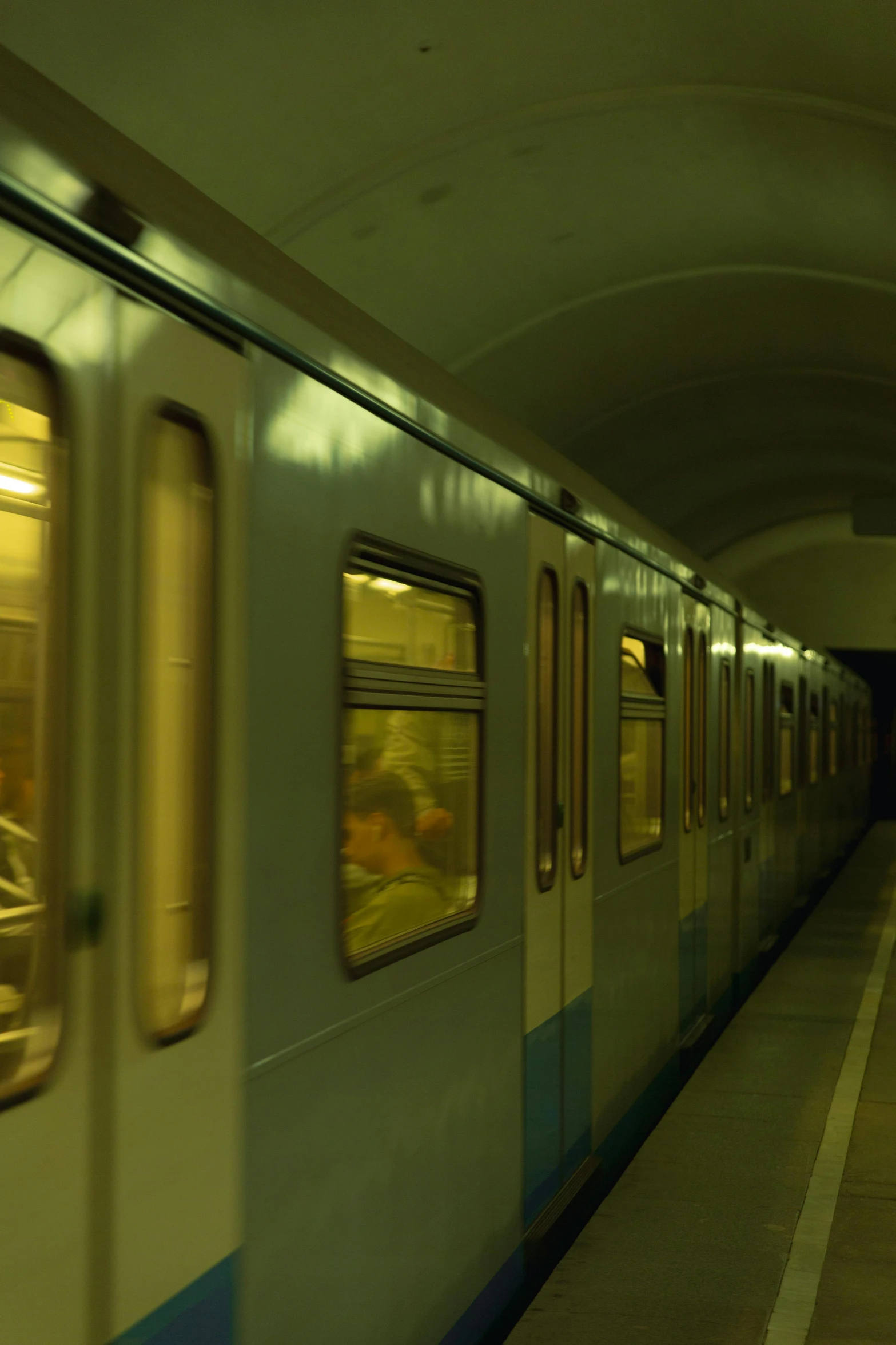 a subway train pulling into a station next to a platform, inspired by Vasily Vereshchagin, flickr, medium format. soft light, green light, doors, warsaw