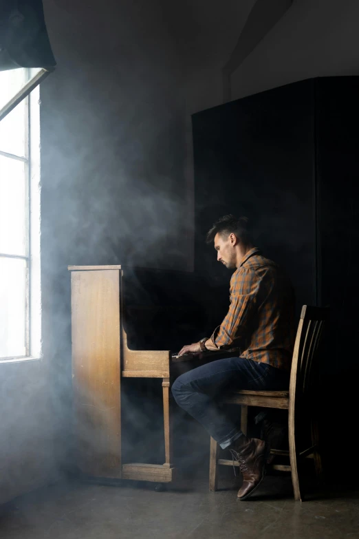 a man sitting at a piano in a dark room, an album cover, inspired by Michael Ray Charles, romanticism, dust clouds | homoerotic, tyler west, 15081959 21121991 01012000 4k, dramatic backlight