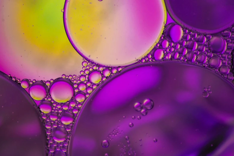 a bunch of bubbles floating on top of each other, a microscopic photo, trending on pexels, generative art, yellow purple, detailed oil, high quality photo, oil slick