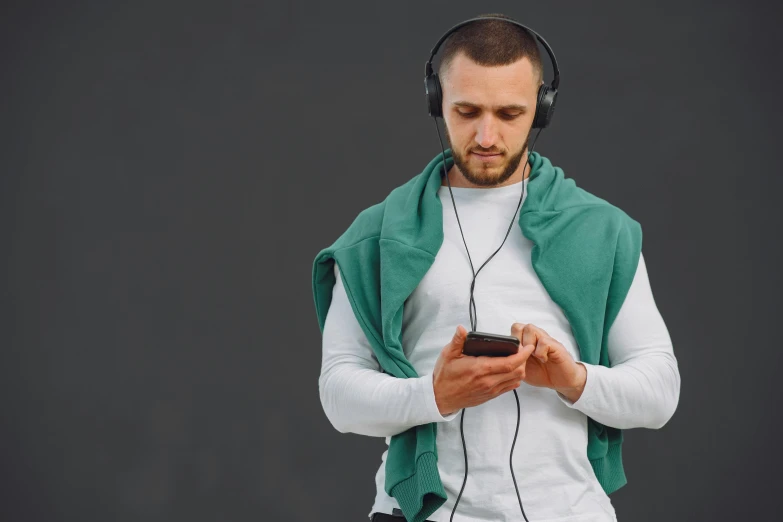 a man in headphones checking his cellphone