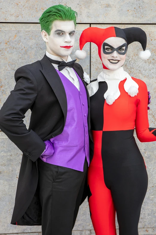 a man and woman in costumes standing next to each other