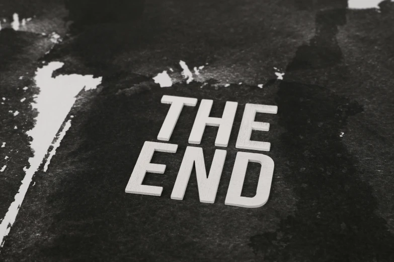 the end logo painted on a piece of black paper