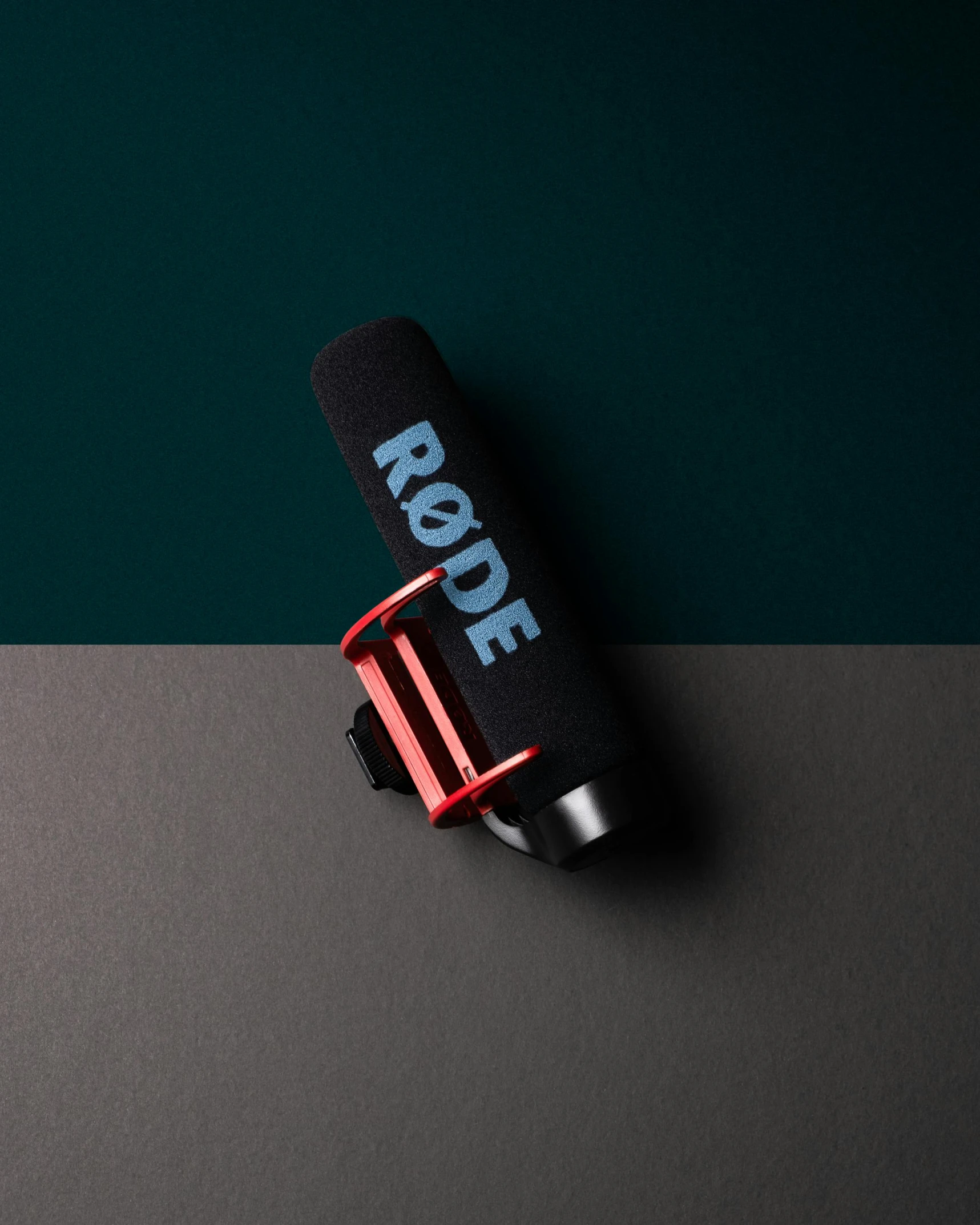 a close up of a microphone on a table, black+velvet+red+turquoise, thumbnail, top down camera angle, neoprene