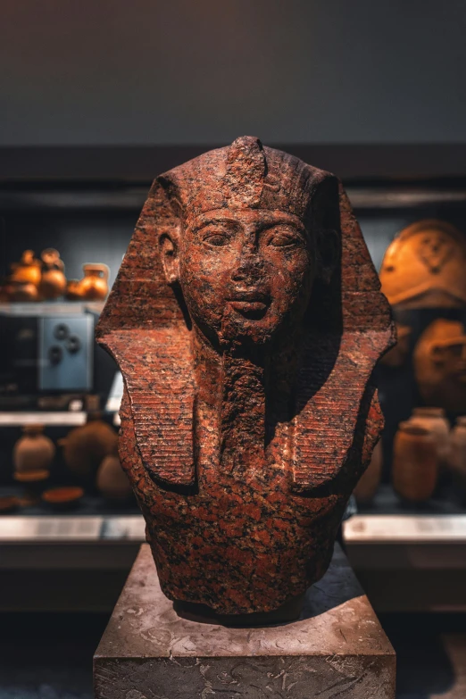 a close up of a statue in a museum, egyptian art, pexels contest winner, black and terracotta, flat triangle - shaped head, curated collection, instagram photo