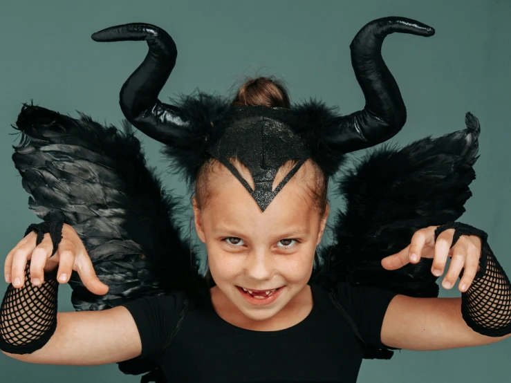 a little girl dressed up as a maleficent, pexels contest winner, goat horns, greta thunberg, harpy, vile