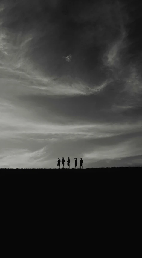 a group of people standing on top of a hill, a black and white photo, minimalism, sunset dark dramatic day, cinematic. ”, instagram photo, style of hiroshi sugimoto