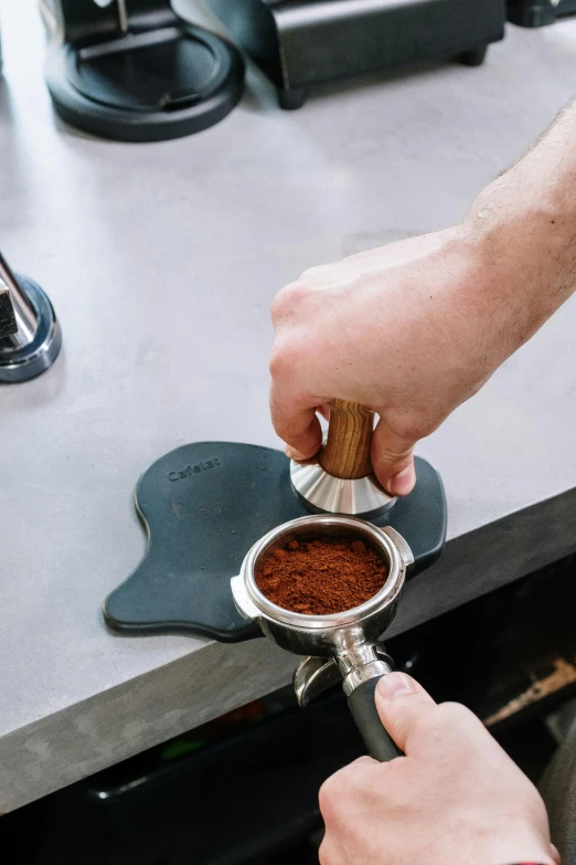 a person grinding seeds on a grinder