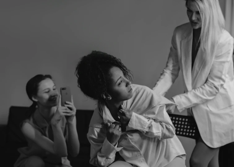 a black and white photo of a woman combing another woman's hair, a black and white photo, by Emma Andijewska, pexels contest winner, wearing white suit, willow smith young, roomies, goddess checking her phone
