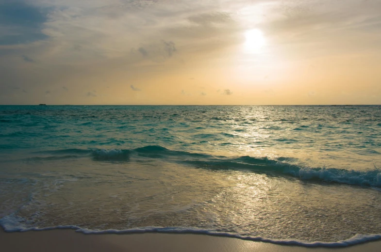 the sun is setting over the ocean on the beach, by Robbie Trevino, pexels contest winner, carribean turquoise water, sunfaded, hd footage, caribbean