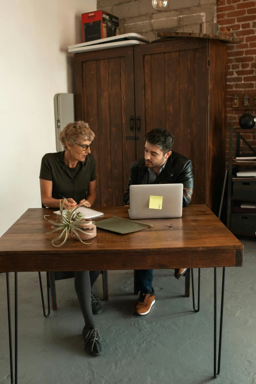 a couple of people sitting at a table with laptops, by Jessie Algie, pexels, renaissance, square, inspect in inventory image, hip corporate, at home