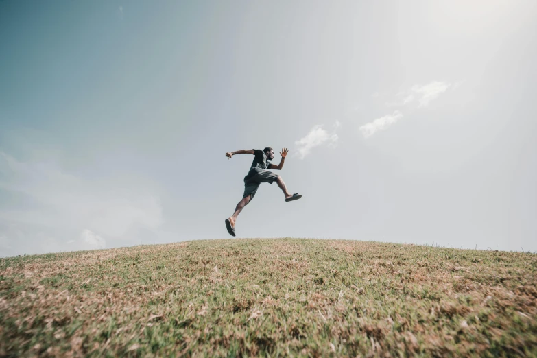 a man flying through the air while riding a skateboard, pexels contest winner, happening, grassy hill, avatar image, working out in the field, black man