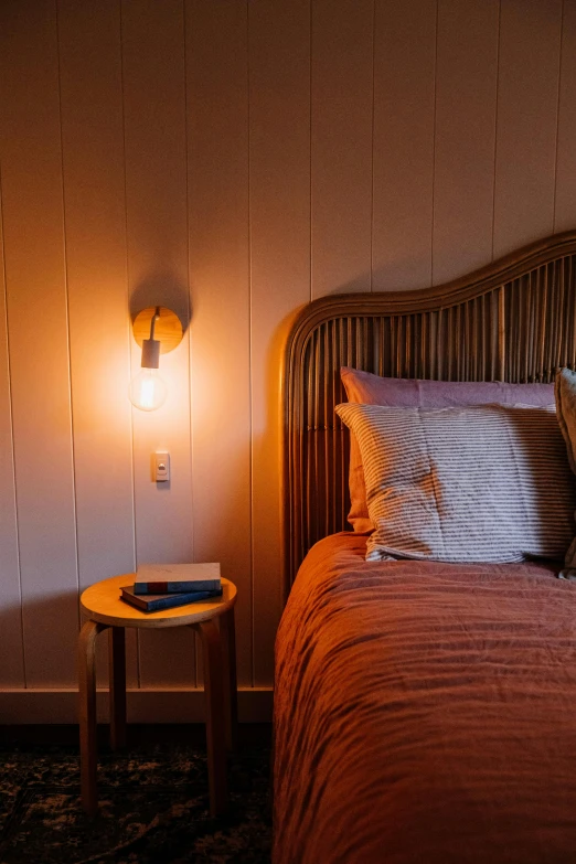 there is an old fashioned bed that has been turned into a table with a lamp