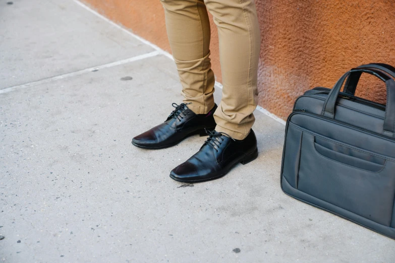 a man standing next to a briefcase on a sidewalk, pexels contest winner, renaissance, black shoes, avatar image, black trousers, professional closeup photo