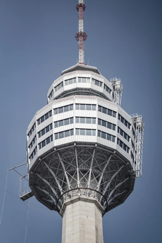 a tall tower sitting in the middle of a blue sky, observation deck, mechanical superstructure, grey, exterior