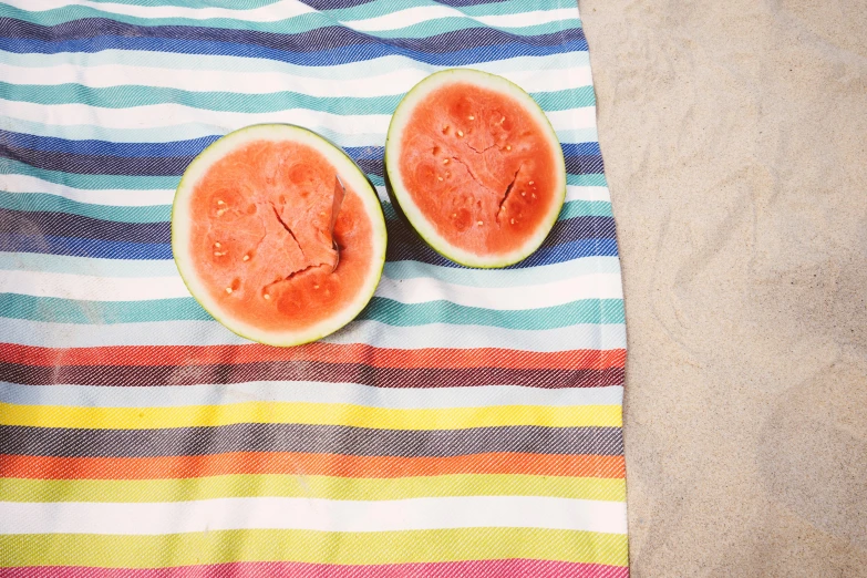 two slices of watermelon on a striped towel, by Helen Stevenson, unsplash, chartreuse and orange and cyan, beach, multicoloured, modeled