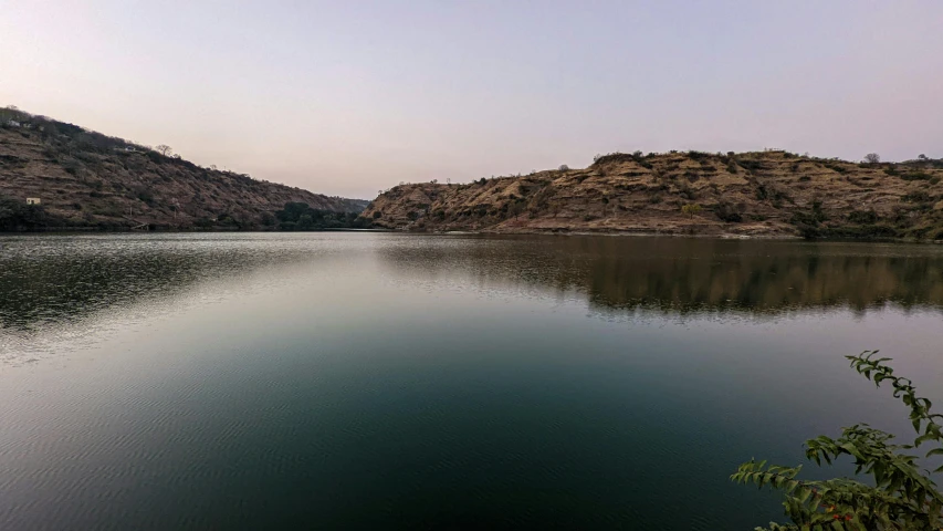 a body of water with a mountain in the background, samikshavad, faded glow, water reservoir, vastayan, high quality photo