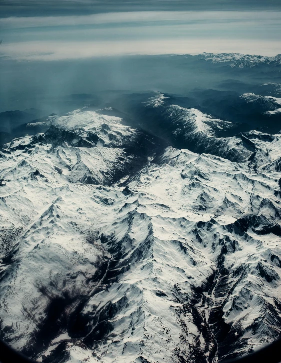the view out of a plane window looking down on mountains