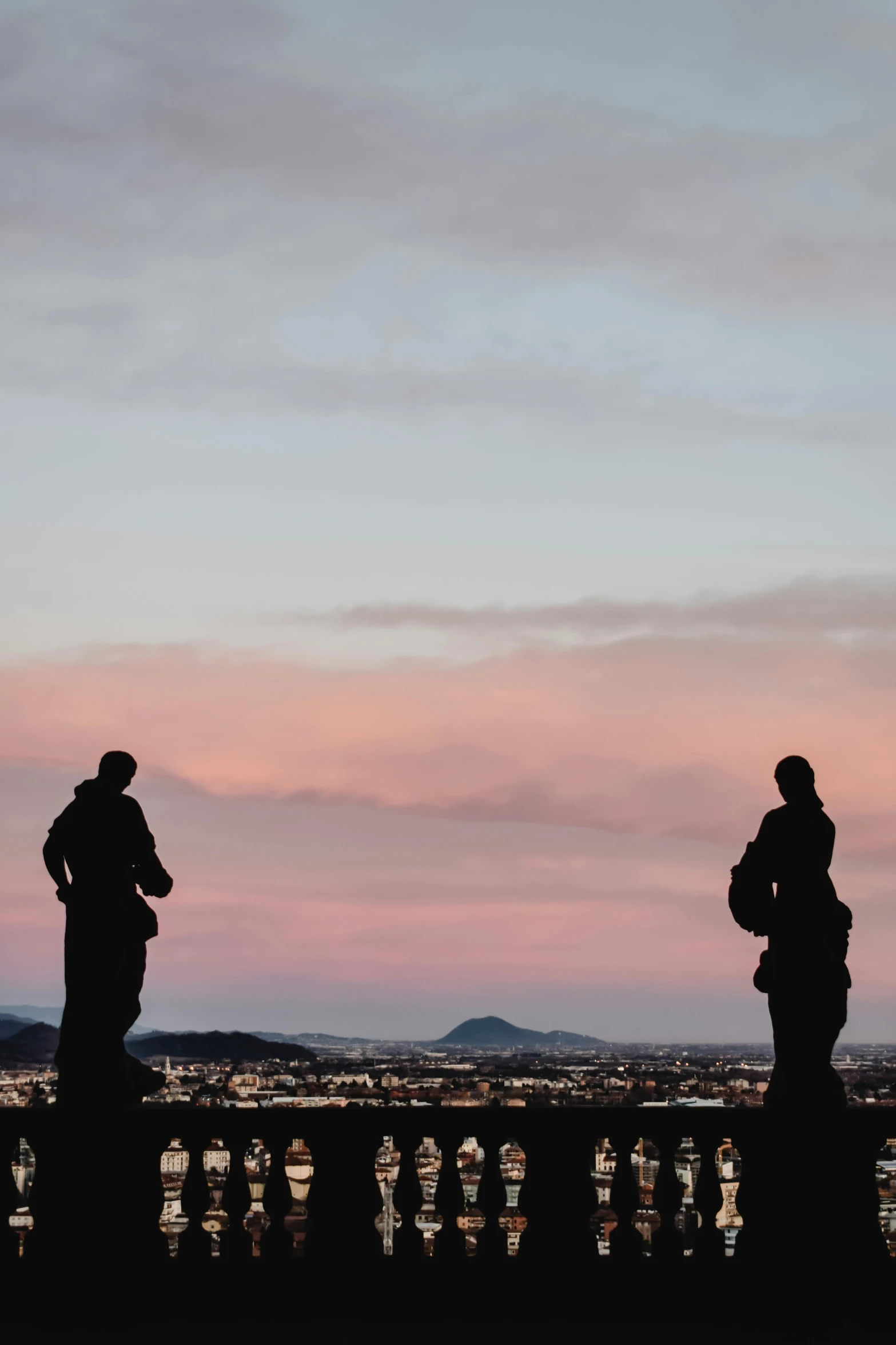 a group of people standing on top of a bridge, a statue, pexels contest winner, edinburgh castle, dawn and dusk, looking onto the horizon, two still figures facing camera