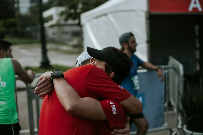 two people hug outside during a marathon